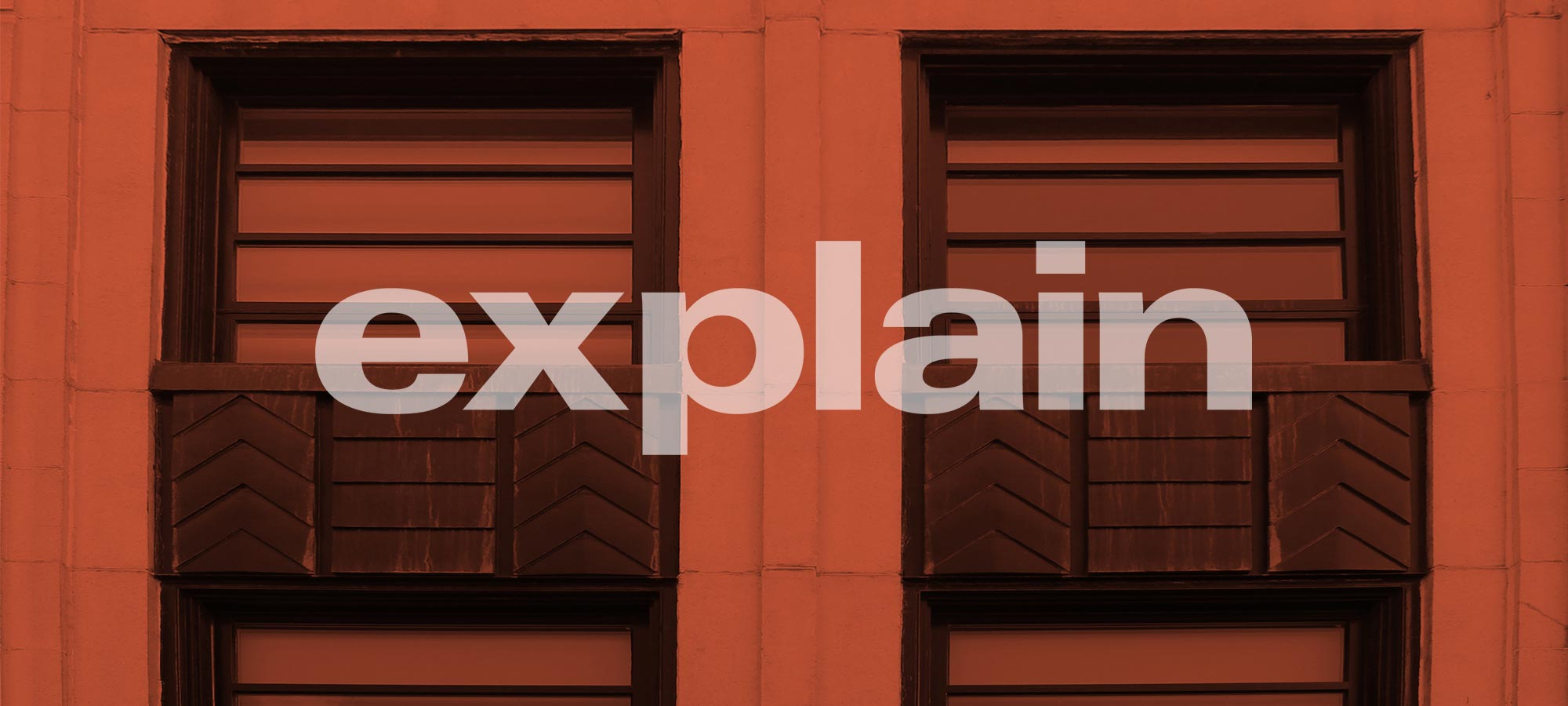 Text that reads ‘explain’ on orange-tinted photo of Art Deco building detail.